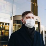 man in black robe wearing white face mask