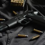 black semi automatic pistol on black textile
