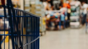 blue shopping cart on street during daytime
