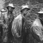 concrete statues near wall